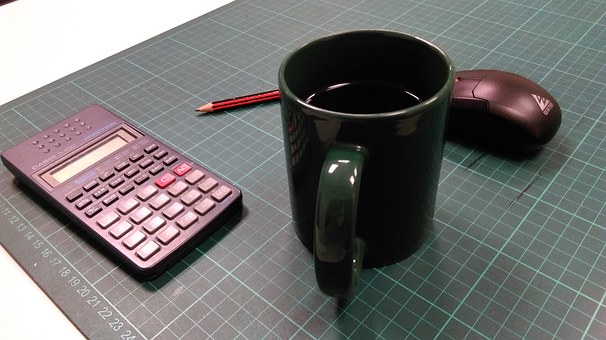 calculator, coffee cup